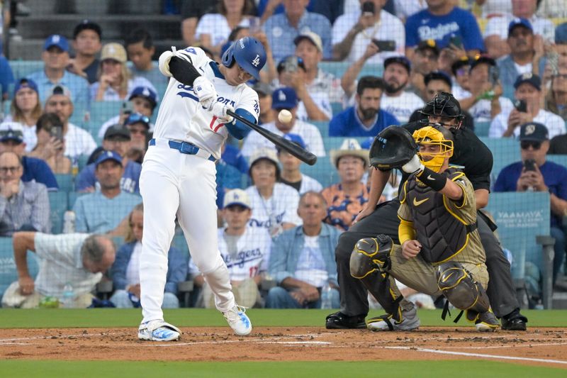 Oct 5, 2024; Los Angeles, California, USA; Los Angeles Dodgers designated hitter Shohei Ohtani (17) flies out in the first inning against the San Diego Padres during game one of the NLDS for the 2024 MLB Playoffs at Dodger Stadium. Mandatory Credit: Jayne Kamin-Oncea-Imagn Images