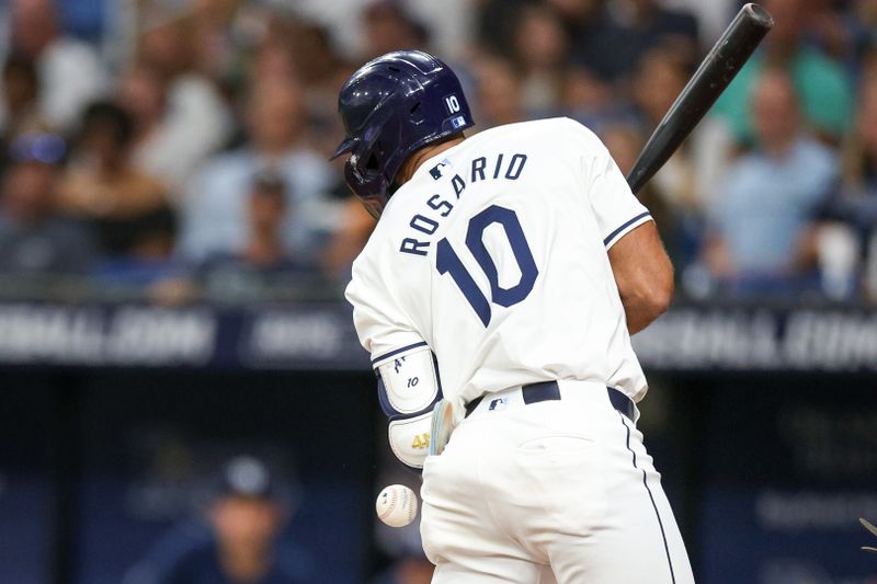 Jul 11, 2024; St. Petersburg, Florida, USA; Tampa Bay Rays second baseman Amed Rosario (10) is hit by a pitch against the New York Yankees in the fifth inning at Tropicana Field. Mandatory Credit: Nathan Ray Seebeck-USA TODAY Sports