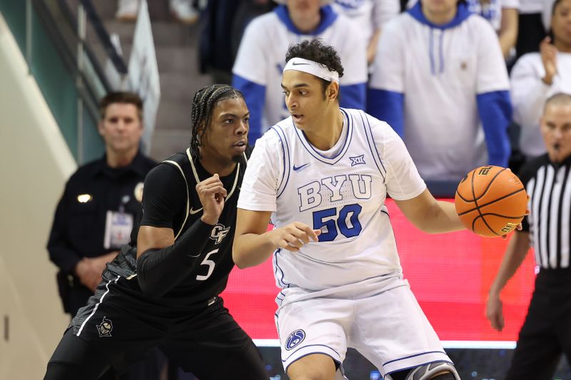 Feb 13, 2024; Provo, Utah, USA; Brigham Young Cougars center Aly Khalifa (50) posts up against Central Florida Knights forward Omar Payne (5) during the first half at Marriott Center. Mandatory Credit: Rob Gray-USA TODAY Sports