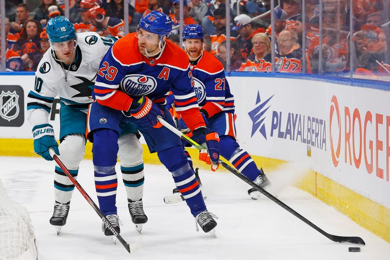 Apr 15, 2024; Edmonton, Alberta, CAN; Edmonton Oilers forward Leon Draisaitl (29) protects the puck from San Jose Sharks forward Klim Kostin (10) during the second period at Rogers Place. Mandatory Credit: Perry Nelson-USA TODAY Sports