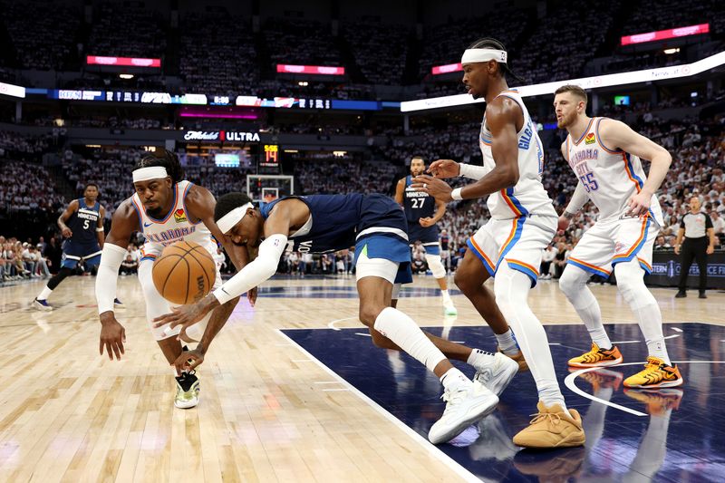 MINNEAPOLIS, MINNESOTA - MAY 24: Luguentz Dort #5 of the Oklahoma City Thunder battles for the ball against Jaden McDaniels #3 of the Minnesota Timberwolves during the third quarter in Game Three of the Western Conference Finals of the 2025 NBA Playoffs at Target Center on May 24, 2025 in Minneapolis, Minnesota. NOTE TO USER: User expressly acknowledges and agrees that, by downloading and or using this photograph, User is consenting to the terms and conditions of the Getty Images License Agreement. (Photo by David Berding/Getty Images)