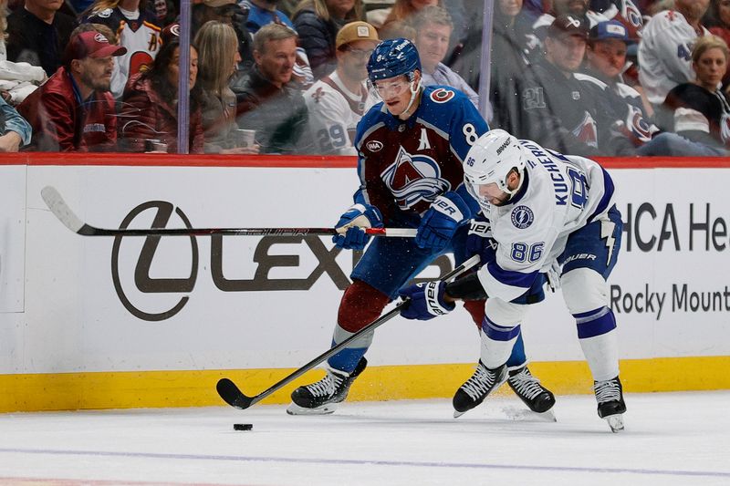 Nov 4, 2025; Denver, Colorado, USA; Colorado Avalanche defenseman Cale Makar (8) and Tampa Bay Lightning right wing Nikita Kucherov (86) battle for the puck in the second period at Ball Arena. Mandatory Credit: Isaiah J. Downing-Imagn Images