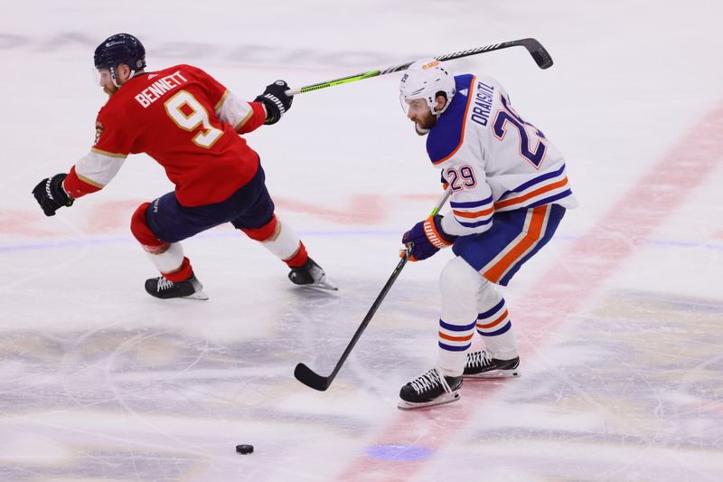 Jun 24, 2024; Sunrise, Florida, USA; Edmonton Oilers forward Leon Draisaitl (29) controls the puck against Florida Panthers forward Sam Bennett (9) during the second period  in game seven of the 2024 Stanley Cup Final at Amerant Bank Arena. Mandatory Credit: Sam Navarro-USA TODAY Sports