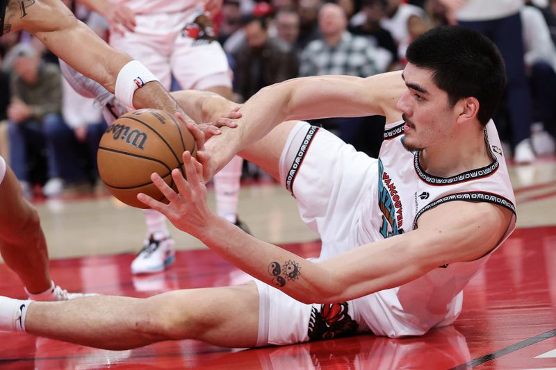 HOUSTON, TEXAS - JANUARY 13: Zach Edey #14 of the Memphis Grizzlies battles for the ball with Dillon Brooks #9 of the Houston Rockets during the first half at Toyota Center on January 13, 2025 in Houston, Texas. NOTE TO USER: User expressly acknowledges and agrees that, by downloading and or using this photograph, User is consenting to the terms and conditions of the Getty Images License Agreement. (Photo by Alex Slitz/Getty Images)