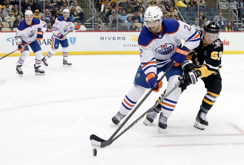 Feb 23, 2023; Pittsburgh, Pennsylvania, USA; Edmonton Oilers defenseman Evan Bouchard (2) handles the puck against pressure from Pittsburgh Penguins left wing Jake Guentzel (59) during the third period at PPG Paints Arena. Edmonton won 7-2. Mandatory Credit: Charles LeClaire-USA TODAY Sports