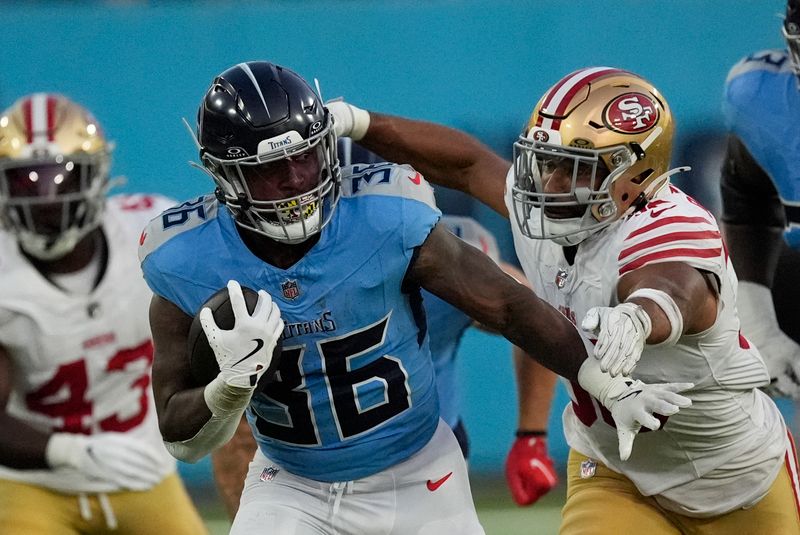 Tennessee Titans running back Julius Chestnut (36) tries to break away from San Francisco 49ers linebacker Curtis Robinson (36) during the first half of an NFL preseason football game, Saturday, Aug. 10, 2024, in Nashville, Tenn. (AP Photo/Mike Stewart)