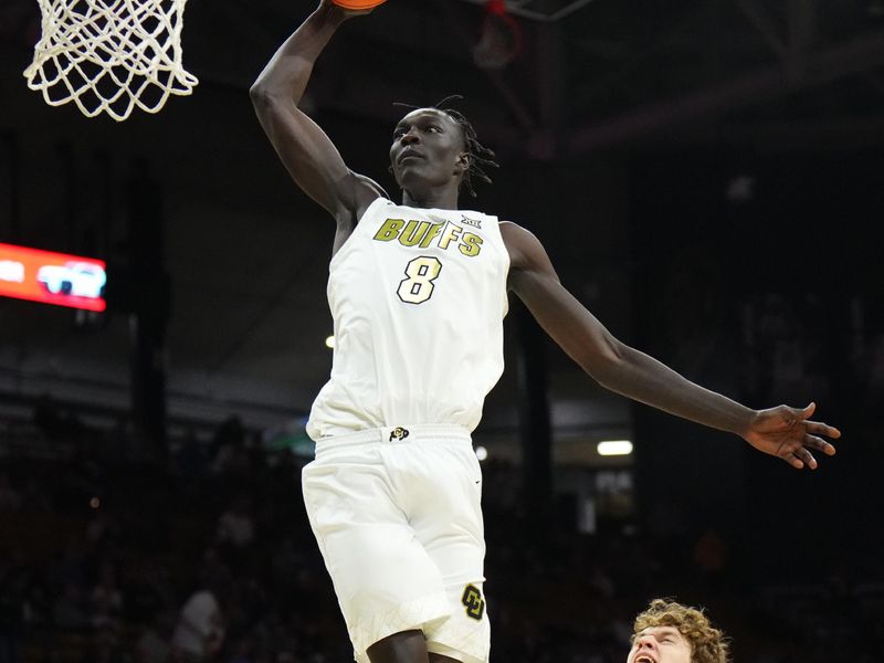 Feb 1, 2026; Boulder, Colorado, USA; Colorado Buffaloes forward Bangot Dak (8) finishes off a basket in the second half against the Texas Christian University Horned Frogs at the CU Events Center. Mandatory Credit: Ron Chenoy-Imagn Images