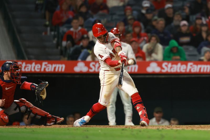 Apr 26, 2024; Anaheim, California, USA;  Los Angeles Angels shortstop Zach Neto (9) hits an RBI single during the ninth inning against the Minnesota Twins at Angel Stadium. Mandatory Credit: Kiyoshi Mio-USA TODAY Sports