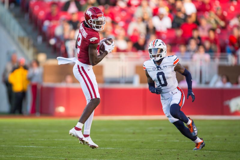 Nov 11, 2023; Fayetteville, Arkansas, USA;  Arkansas Razorbacks wide receiver Andrew Armstrong (2) makes a catch as Auburn Tigers cornerback Keionte Scott (0) defends during the second quarter at Donald W. Reynolds Razorback Stadium. Mandatory Credit: Brett Rojo-USA TODAY Sports