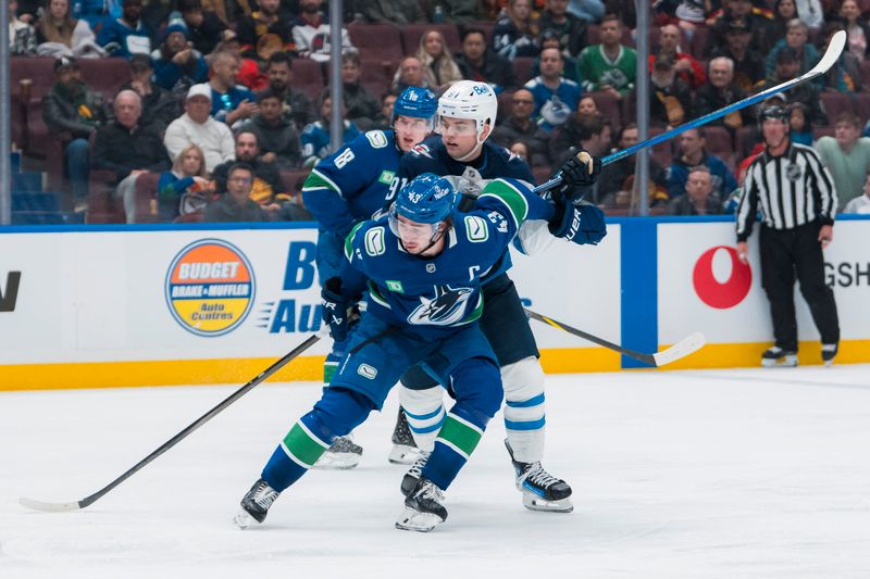 Mar 18, 2025; Vancouver, British Columbia, CAN; Vancouver Canucks defenseman Quinn Hughes (43) battles with Winnipeg Jets forward Cole Perfetti (91) in the third period at Rogers Arena. Mandatory Credit: Bob Frid-Imagn Images