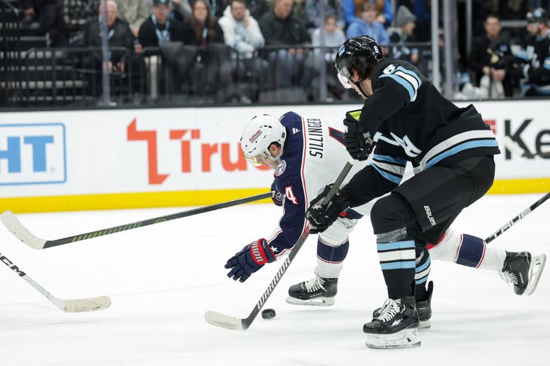 Jan 31, 2025; Salt Lake City, Utah, USA;  Utah Hockey Club defenseman John Marino (6) knocks the puck away from Columbus Blue Jackets center Cole Sillinger (4) during the first period at Delta Center. Mandatory Credit: Chris Nicoll-Imagn Images