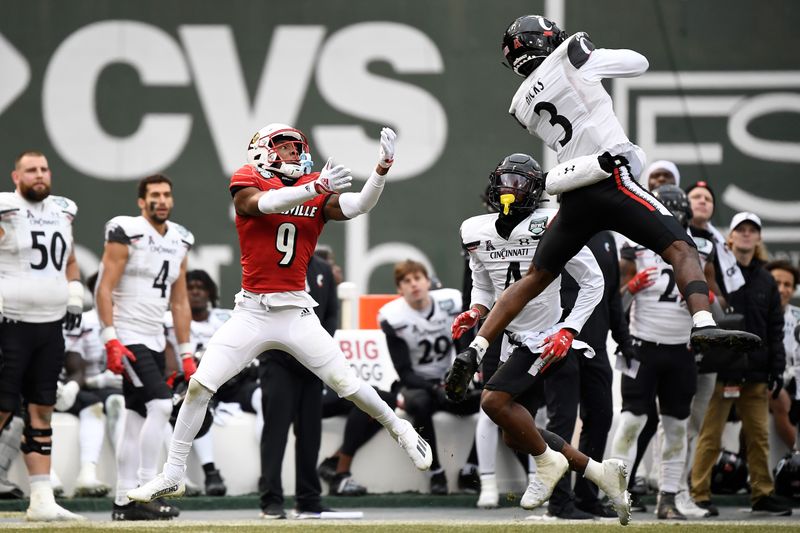 Dec 17, 2022; Boston, MA, USA; Cincinnati Bearcats safety Ja'von Hicks (3) intercepts a pass intended for Louisville Cardinals wide receiver Ahmari Huggins-Bruce (9) during the second half at Fenway Park. Mandatory Credit: Eric Canha-USA TODAY Sports