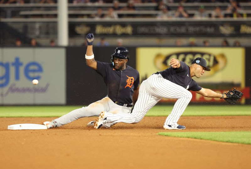 Feb 27, 2023; Tampa, Florida, USA;  Detroit Tigers left fielder Akil Baddoo (60) steals second base as New York Yankees shortstop Isiah Kiner-Falefa (12) misses the ball aduring the first inning at George M. Steinbrenner Field. Mandatory Credit: Kim Klement-USA TODAY Sports