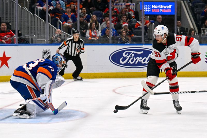 Dec 23, 2025; Elmont, New York, USA;  New Jersey Devils center Dawson Mercer (91) attempts a backhand shot on New York Islanders goaltender David Rittich (33) during the third period at UBS Arena. Mandatory Credit: Dennis Schneidler-Imagn Images