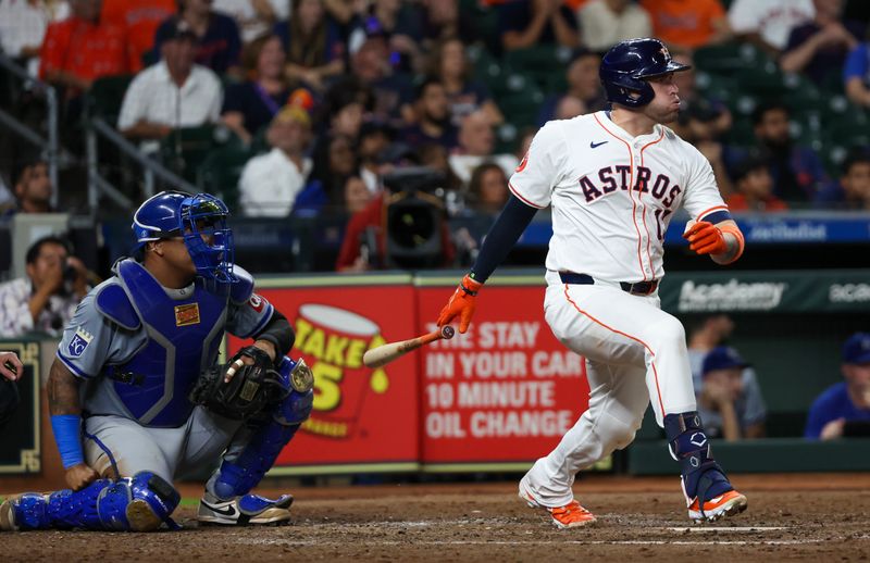 Aug 29, 2024; Houston, Texas, USA;  Houston Astros pitch hitter Victor Caratini (17) hits a single against the Kansas City Royals in the eighth inning at Minute Maid Park. Mandatory Credit: Thomas Shea-USA TODAY Sports