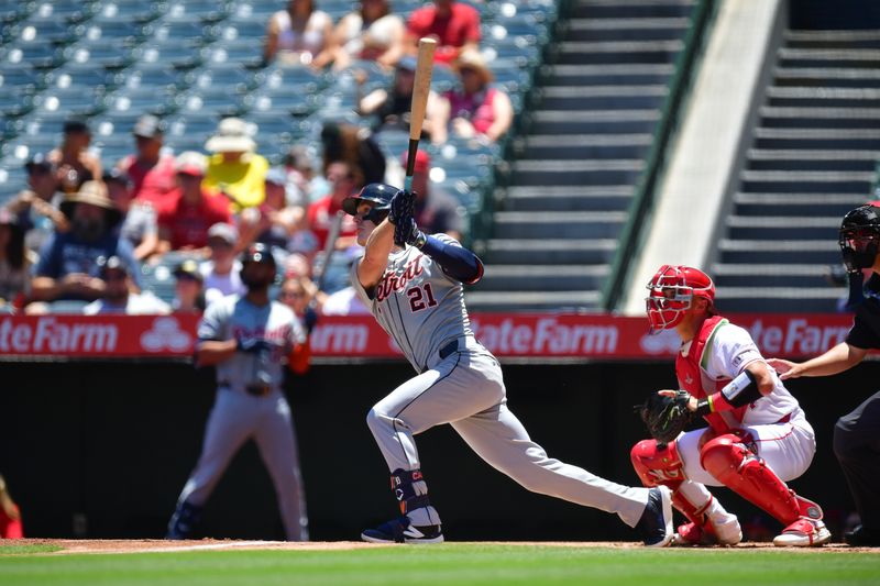 Jun 27, 2024; Anaheim, California, USA; Detroit Tigers outfielder Mark Canha (21) hits a sacrifice RBI against the Los Angeles Angels during the first inning at Angel Stadium. Mandatory Credit: Gary A. Vasquez-USA TODAY Sports