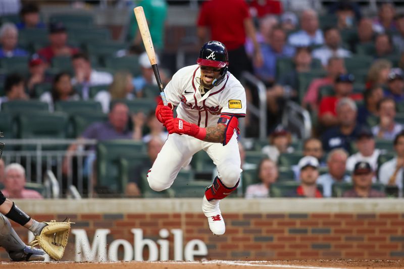 Sep 3, 2024; Atlanta, Georgia, USA; Atlanta Braves shortstop Orlando Arcia (11) gets out of the way of a pitch against the Colorado Rockies in the third inning at Truist Park. Mandatory Credit: Brett Davis-Imagn Images 
