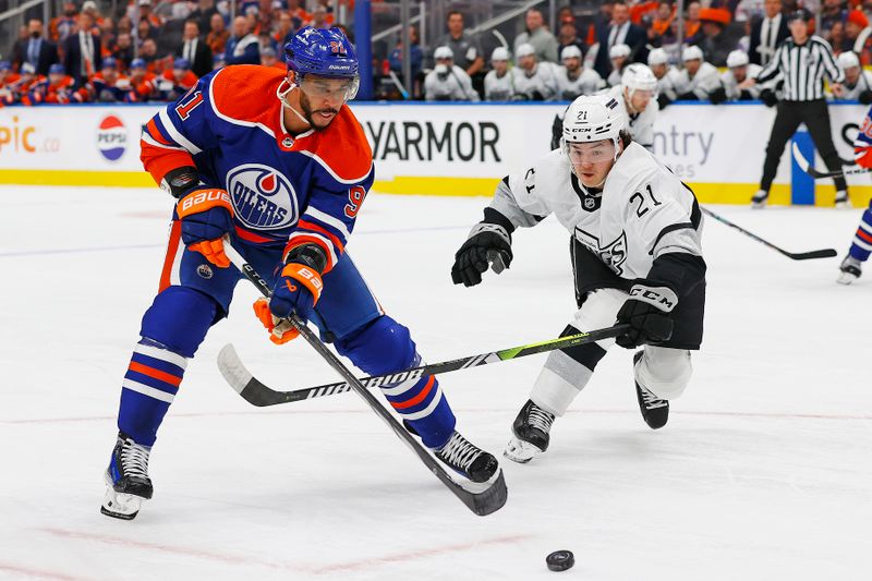 Apr 22, 2024; Edmonton, Alberta, CAN;Edmonton Oilers forward Evander Kane (91) and Los Angeles Kings defensemen Jordan Spence (21) chase a loose puck during the first period in game one of the first round of the 2024 Stanley Cup Playoffs at Rogers Place. Mandatory Credit: Perry Nelson-USA TODAY Sports