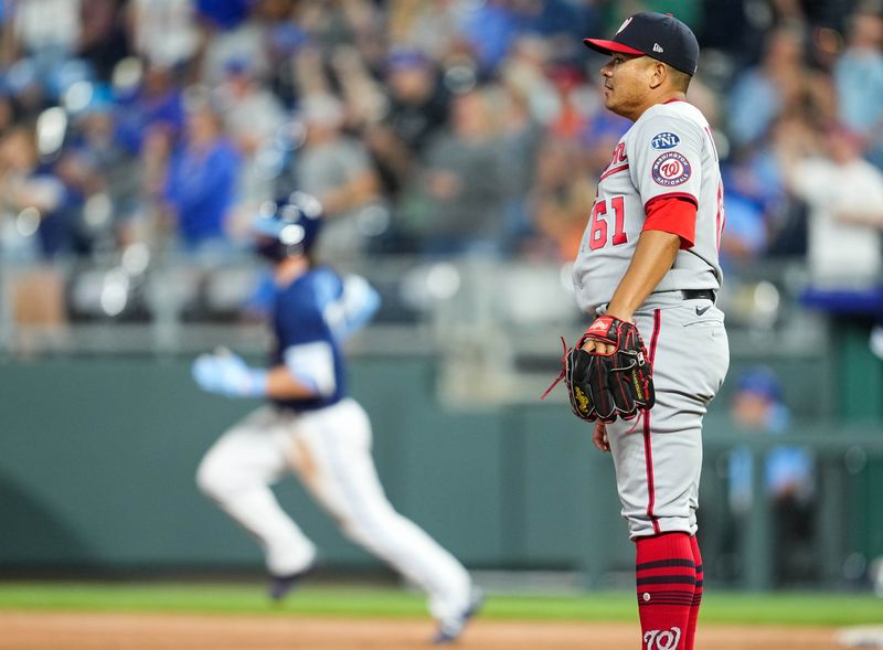 May 26, 2023; Kansas City, Missouri, USA; Washington Nationals relief pitcher Erasmo Ramirez (61) watches after giving up a home run to Kansas City Royals shortstop Bobby Witt Jr. (7) during the seventh inning at Kauffman Stadium. Mandatory Credit: Jay Biggerstaff-USA TODAY Sports