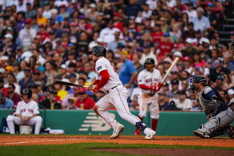 Jul 31, 2024; Boston, Massachusetts, USA; Boston Red Sox catcher Danny Jansen (28) singles to right field to drive in a run against the Seattle Mariners in the sixth inning at Fenway Park. Mandatory Credit: David Butler II-USA TODAY Sports