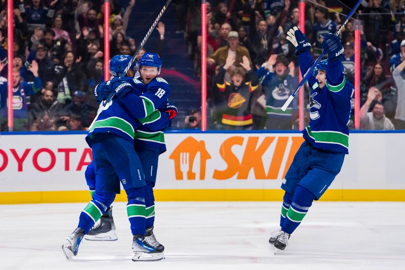 Dec 9, 2023; Vancouver, British Columbia, CAN; Vancouver Canucks forward Elias Pettersson (40) and forward Sam Lafferty (18) and forward Ilya Mikheyev (65) celebrate Pettersson   s goal against the Carolina Hurricanes in the third period at Rogers Arena. Vancouver won 4-3. Mandatory Credit: Bob Frid-USA TODAY Sports