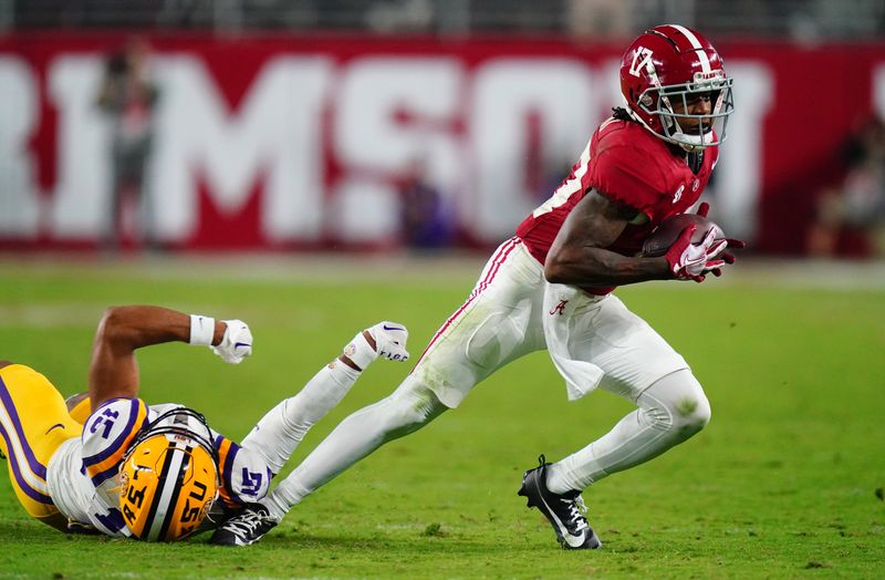 Nov 4, 2023; Tuscaloosa, Alabama, USA; Alabama Crimson Tide wide receiver Isaiah Bond (17) hauls in a pass against LSU Tigers safety Sage Ryan (15) during the second half at Bryant-Denny Stadium. Alabama Crimson Tide defeated the LSU Tigers 42-28. Mandatory Credit: John David Mercer-USA TODAY Sports