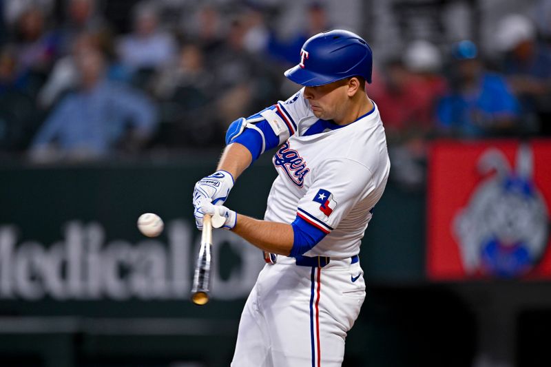 Aug 7, 2024; Arlington, Texas, USA;  Texas Rangers first baseman Nathaniel Lowe (30) hits a single against the Houston Astros during the fourth inning at Globe Life Field. Mandatory Credit: Jerome Miron-USA TODAY Sports