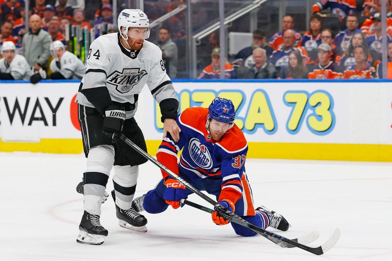 May 1, 2024; Edmonton, Alberta, CAN; Los Angeles Kings defensemen Vladislav Gavrikov (84) trips up Edmonton Oilers forward Warren Foegele (37) during the third period in game five of the first round of the 2024 Stanley Cup Playoffs at Rogers Place. Mandatory Credit: Perry Nelson-USA TODAY Sports