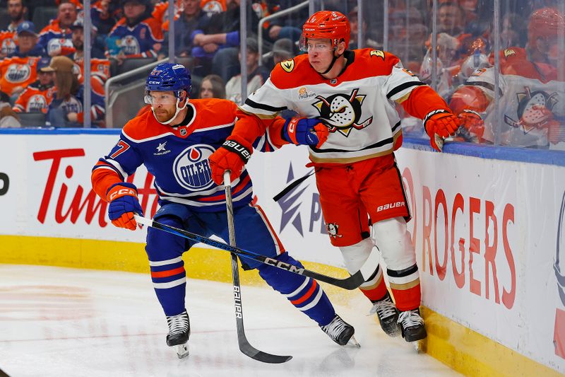 Jan 3, 2025; Edmonton, Alberta, CAN; Edmonton Oilers defensemen Brett Kulak (27) and Anaheim Ducks defensemen Jackson LaCombe (2) look for a loose puck during the second period at Rogers Place. Mandatory Credit: Perry Nelson-Imagn Images