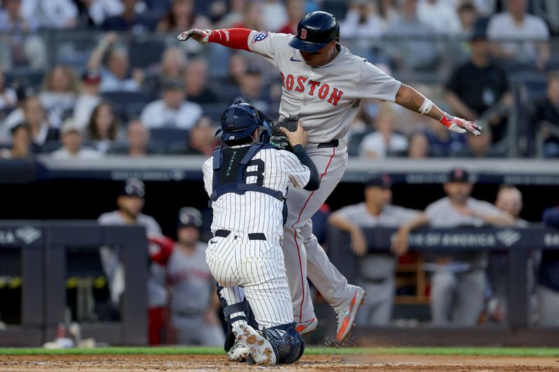 Jun 7, 2025; Bronx, New York, USA; New York Yankees catcher Austin Wells (28) tags out Boston Red Sox designated hitter Rafael Devers (11) trying to score on a fielders choice ground ball by catcher Carlos Narvaez (not pictured) during the third inning at Yankee Stadium. Mandatory Credit: Brad Penner-Imagn Images