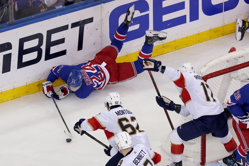 May 30, 2024; New York, New York, USA; New York Rangers right wing Kaapo Kakko (24) plays the puck against Florida Panthers defenseman Brandon Montour (62) and centers Sam Bennett (9) and Evan Rodrigues (17) during the third period of game five of the Eastern Conference Final of the 2024 Stanley Cup Playoffs at Madison Square Garden. Mandatory Credit: Brad Penner-USA TODAY Sports