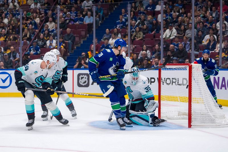 Sep 24, 2024; Vancouver, British Columbia, CAN; Seattle Kraken defenseman Jamie Oleksiak (24) and goalie Joey Daccord (35) watch the shot from Vancouver Canucks forward Sammy Blais (79) hit the post during the first period at Rogers Arena. Mandatory Credit: Bob Frid-Imagn Images