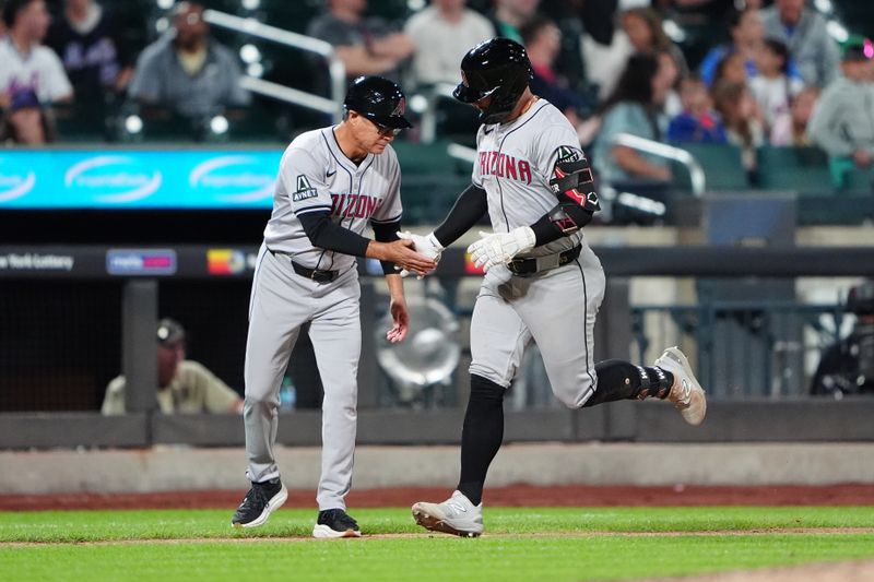 May 31, 2024; New York City, New York, USA;  Arizona Diamondbacks third base coach Tony Perezchica (21) congratulates first baseman Christian Walker (53) for hitting a home run as he rounds the bases during the ninth inning against the New York Mets at Citi Field. Mandatory Credit: Gregory Fisher-USA TODAY Sports