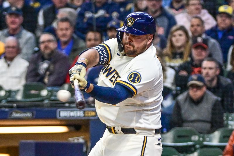 Apr 26, 2023; Milwaukee, Wisconsin, USA; Milwaukee Brewers first baseman Rowdy Tellez (11) hits a two-run RBI double in the first inning during game against Detroit Tigers at American Family Field. Mandatory Credit: Benny Sieu-USA TODAY Sports