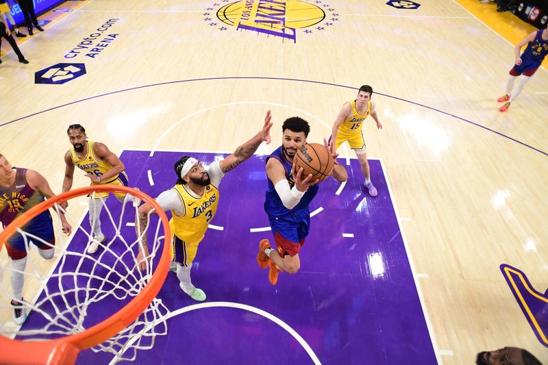 LOS ANGELES, CA - APRIL 25: Jamal Murray #27 of the Denver Nuggets drives to the basket during the game against the Los Angeles Lakers during Round One Game Three of the 2024 NBA Playoffs on April 25, 2024 at Crypto.Com Arena in Los Angeles, California. NOTE TO USER: User expressly acknowledges and agrees that, by downloading and/or using this Photograph, user is consenting to the terms and conditions of the Getty Images License Agreement. Mandatory Copyright Notice: Copyright 2024 NBAE (Photo by Adam Pantozzi/NBAE via Getty Images)