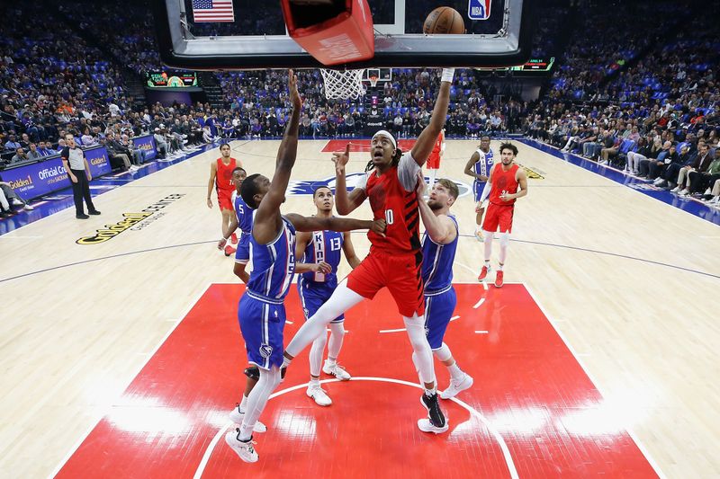 SACRAMENTO, CALIFORNIA - APRIL 14: Moses Brown #10 of the Portland Trail Blazers goes to the basket against Harrison Barnes #40 of the Sacramento Kings in the first quarter\ at Golden 1 Center on April 14, 2024 in Sacramento, California. NOTE TO USER: User expressly acknowledges and agrees that, by downloading and or using this photograph, User is consenting to the terms and conditions of the Getty Images License Agreement. (Photo by Lachlan Cunningham/Getty Images)