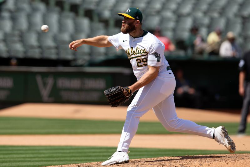 Apr 17, 2024; Oakland, California, USA; Oakland Athletics pitcher Austin Adams (29) delivers a pitch against the St. Louis Cardinals during the seventh inning at Oakland-Alameda County Coliseum. Mandatory Credit: D. Ross Cameron-USA TODAY Sports