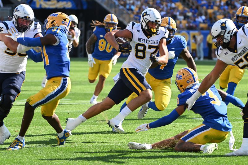 Sep 14, 2024; Pittsburgh, Pennsylvania, USA; West Virginia Mountaineers tight end Kole Taylor (87) runs the ball against Pittsburgh Panthers defensive back Donovan McMillon (3) during the second quarter at Acrisure Stadium. Mandatory Credit: Barry Reeger-Image Images