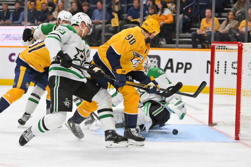 Oct 26, 2025; Nashville, Tennessee, USA;  Nashville Predators center Ryan O'Reilly (90) flips the puck atDallas Stars goaltender Casey Desmith (1) during the first period at Bridgestone Arena. Mandatory Credit: Steve Roberts-Imagn Images