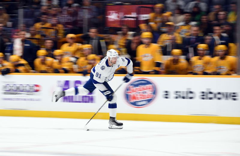 Dec 7, 2023; Nashville, Tennessee, USA; Tampa Bay Lightning center Steven Stamkos (91) plays the puck into the offensive zone during the second period against the Nashville Predators at Bridgestone Arena. Mandatory Credit: Christopher Hanewinckel-USA TODAY Sports