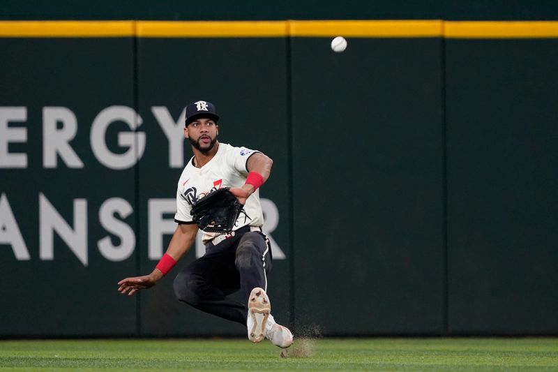 Jul 5, 2024; Arlington, Texas, USA; Texas Rangers outfielder Leody Taveras (3) makes the catch of a fly ball during the seventh inning against the Tampa Bay Rays at Globe Life Field. Mandatory Credit: Raymond Carlin III-USA TODAY Sports