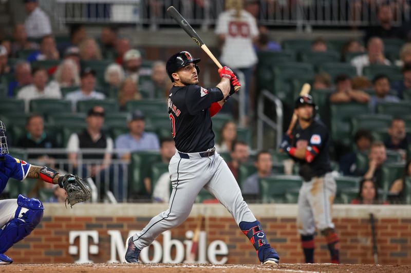 Apr 27, 2024; Atlanta, Georgia, USA; Cleveland Guardians right fielder Ramon Laureano (10) drives in a run on a sacrifice fly against the Atlanta Braves in the eleventh inning at Truist Park. Mandatory Credit: Brett Davis-USA TODAY Sports