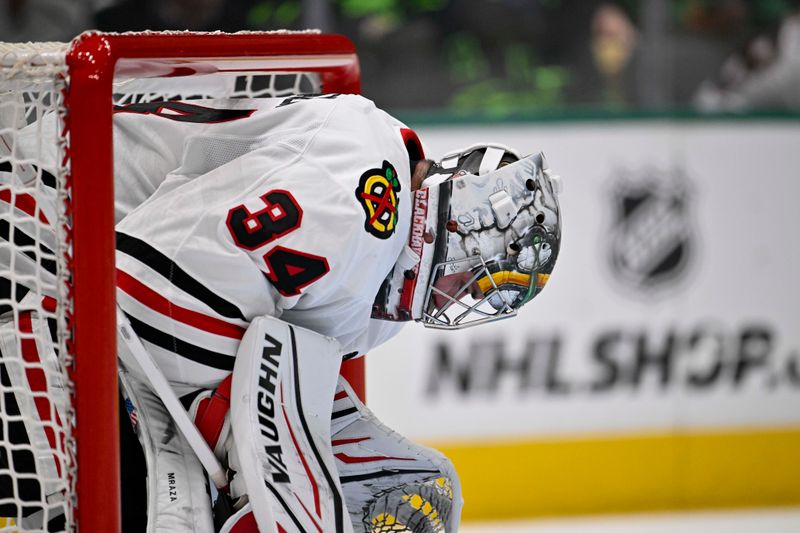 Oct 26, 2024; Dallas, Texas, USA; Chicago Blackhawks goaltender Petr Mrazek (34) looks down during the second period against the Dallas Stars at the American Airlines Center. Mandatory Credit: Jerome Miron-Imagn Images