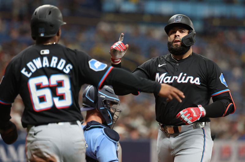 Jul 30, 2024; St. Petersburg, Florida, USA; Miami Marlins third base Emmanuel Rivera (15) is congratulated by shortstop Xavier Edwards (63) after he hit a two-run home run against the Tampa Bay Rays during the first inning at Tropicana Field. Mandatory Credit: Kim Klement Neitzel-USA TODAY Sports