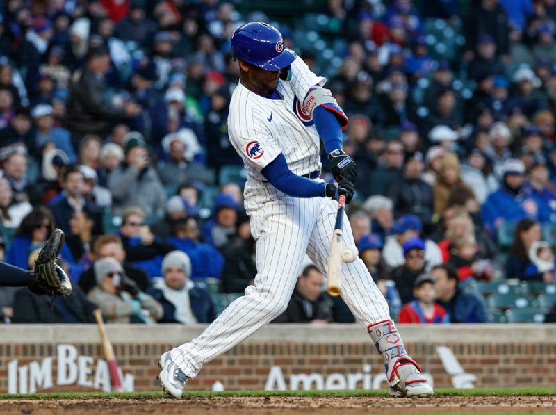Apr 24, 2024; Chicago, Illinois, USA; Chicago Cubs outfielder Alexander Canario (4) singles against the Houston Astros during the second inning at Wrigley Field. Mandatory Credit: Kamil Krzaczynski-USA TODAY Sports