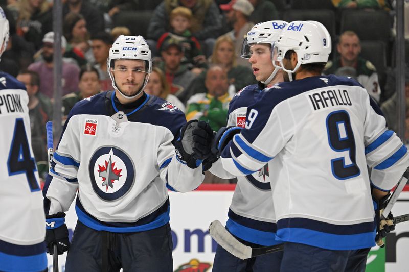 Sep 27, 2024; Saint Paul, Minnesota, USA;  Winnipeg Jets forward Nikita Chibrikov (90) celebrates his power play goal against the Minnesota Wild with forward Alex Iafallo (9) during the third period at Xcel Energy Center. Mandatory Credit: Nick Wosika-Imagn Images

