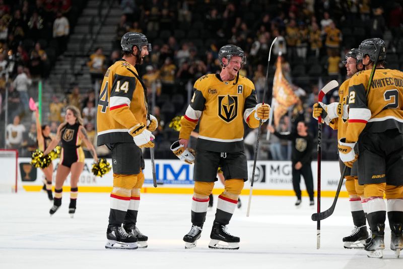 Oct 9, 2024; Las Vegas, Nevada, USA; Vegas Golden Knights center Jack Eichel (9) skates off the ice with defenseman Nicolas Hague (14) after defeating the Colorado Avalanche at T-Mobile Arena. Mandatory Credit: Lucas Peltier-Imagn Images