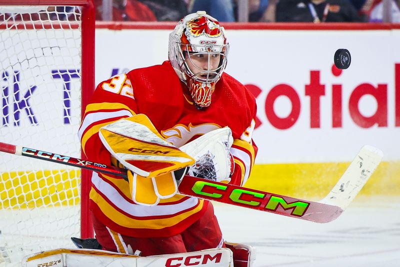 Mar 16, 2024; Calgary, Alberta, CAN; Calgary Flames goaltender Dustin Wolf (32) makes a save against the Montreal Canadiens during the third period at Scotiabank Saddledome. Mandatory Credit: Sergei Belski-USA TODAY Sports