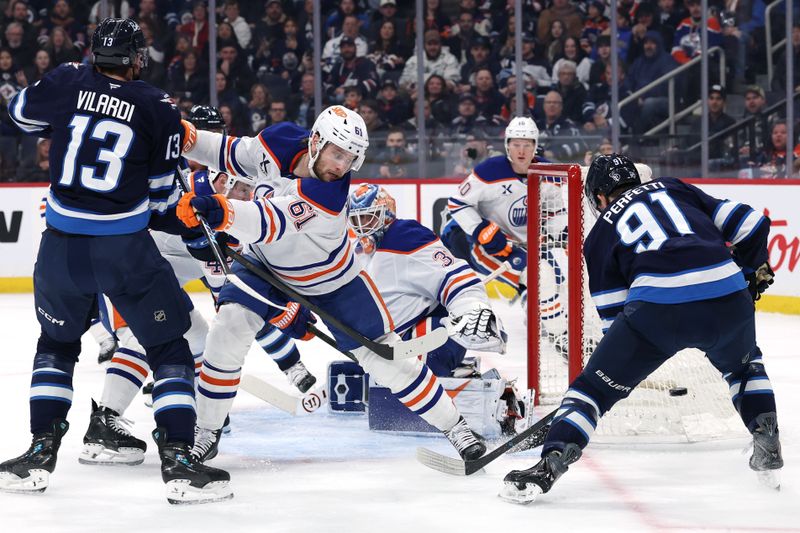 Jan 8, 2026; Winnipeg, Manitoba, CAN; Edmonton Oilers defenseman Riley Stillman (61) and Winnipeg Jets center Cole Perfetti (91) scramble for a rebound in front of  Edmonton Oilers goaltender Calvin Pickard (30) in the second period at Canada Life Centre. Mandatory Credit: James Carey Lauder-Imagn Images
