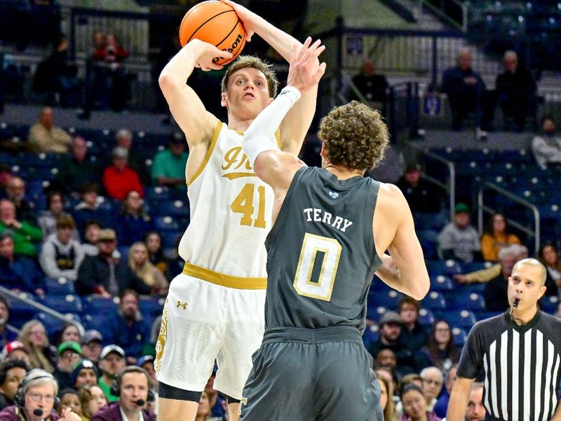 Jan 28, 2025; South Bend, Indiana, USA; Notre Dame Fighting Irish guard Matt Allocco (41) shoots over Georgia Tech Yellow Jackets guard Lance Terry (0) in the first half at the Purcell Pavilion. Mandatory Credit: Matt Cashore-Imagn Images